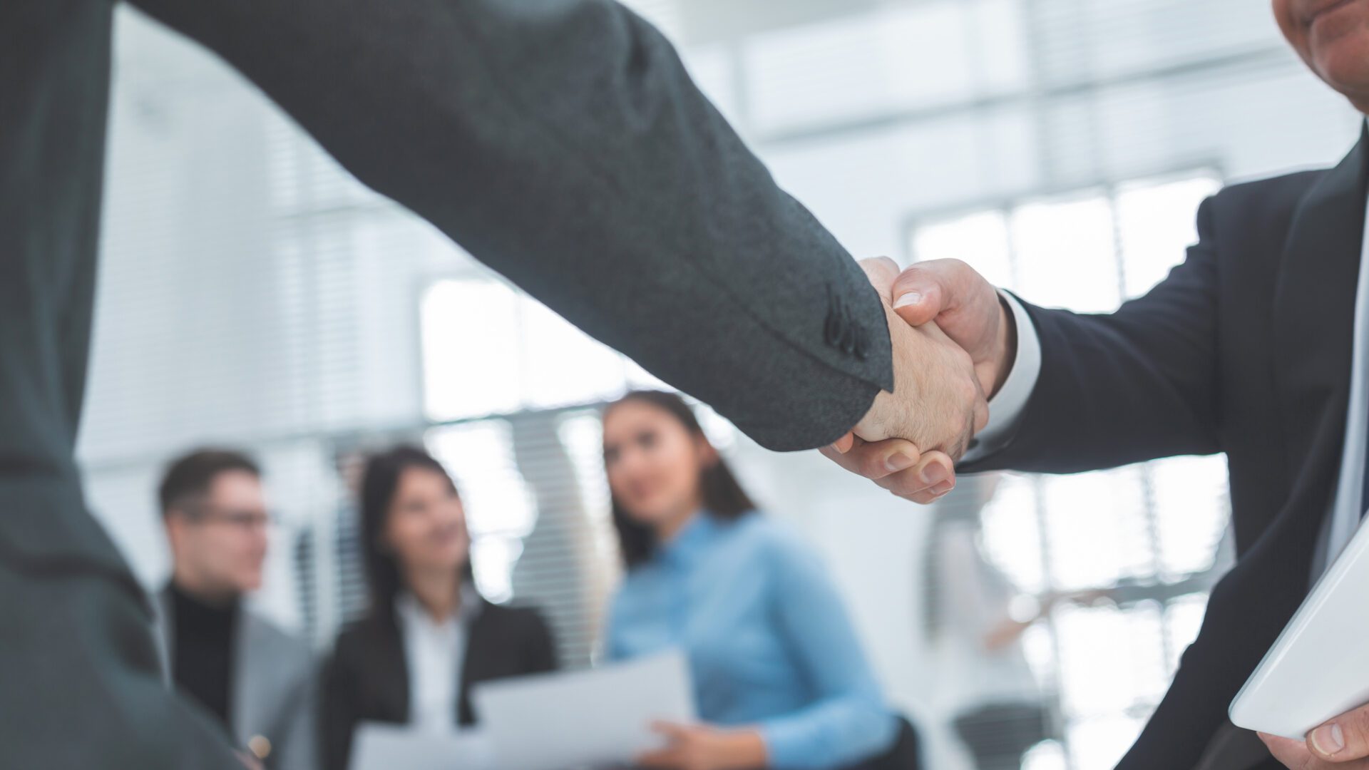 close up. handshake of business partners in the background of the office. close up. handshake of business partners in the background of the office. concept of cooperation